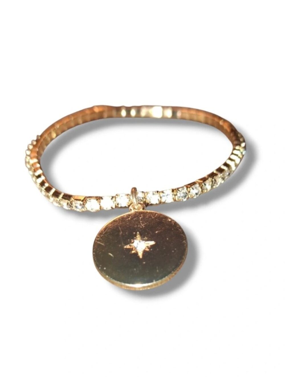 Goldtone tennis bracelet stretch with round crystal disk
